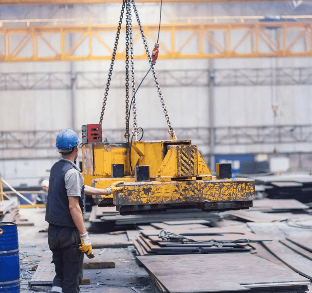 Industrial crane lifting heavy machinery on an Arizona job site